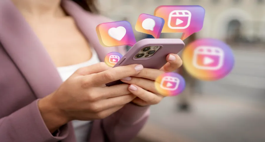 a person holding a pink phone with a lot of Instagram logos floating around her