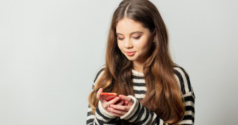 young girl checking her phone