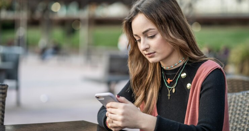 young girl scrolling on her phone