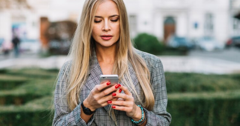 girl checking phone looking serious