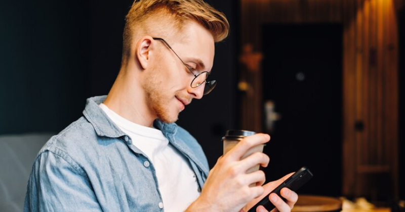 man scrolling on phone