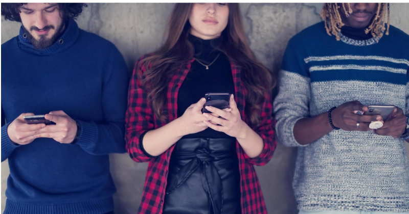 group of people checking their phones