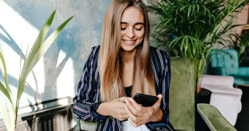 girl checking her phone looking excited