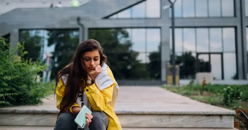 a girl waiting on starir