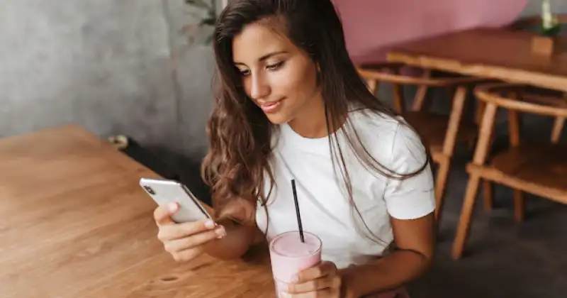 girl checking her phone looking happy