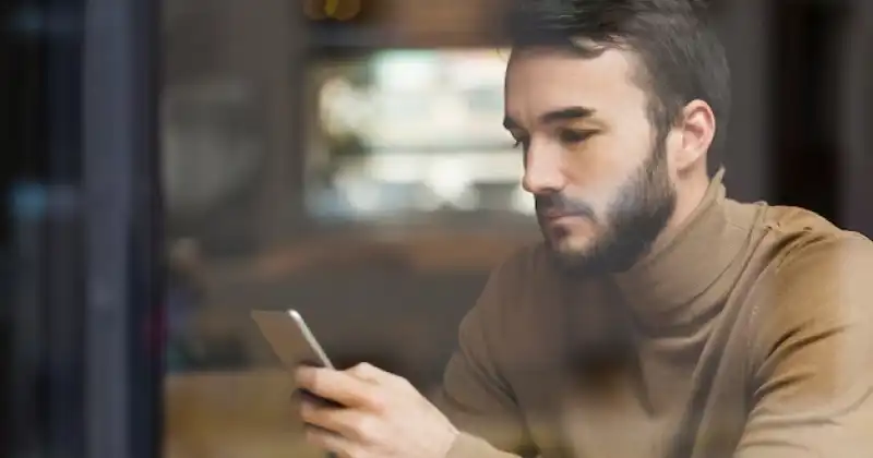 A guy is checking social media