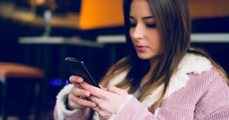 girl scrolling on her phone