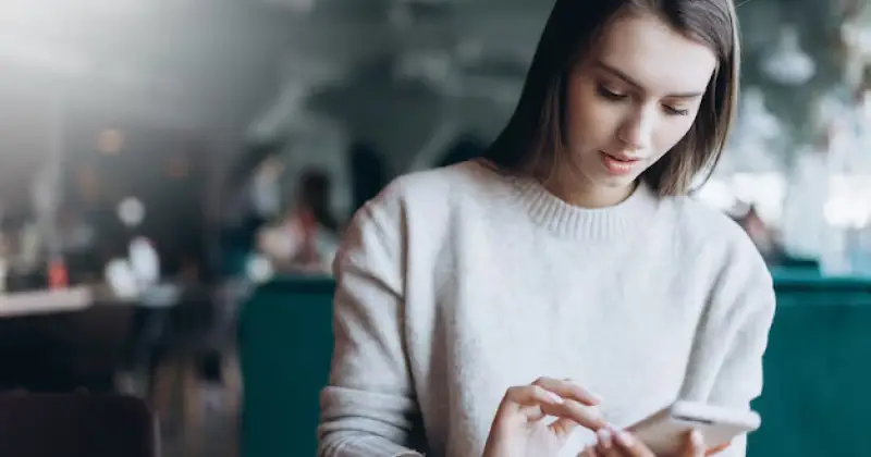 girl scrolling on her phone