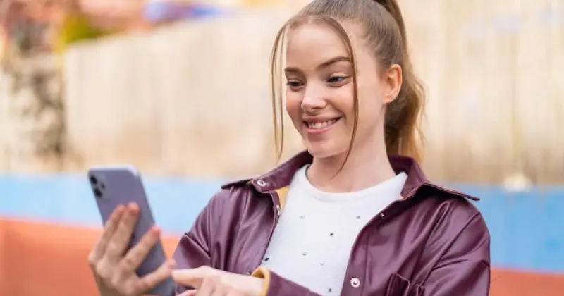 girl checking her phone looking excited