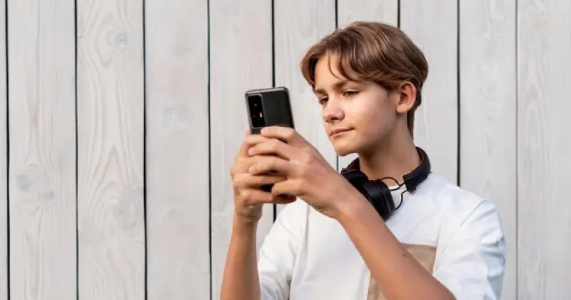 boy checking his phone