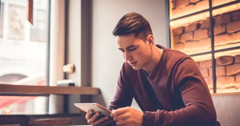guy scrolling on his phone