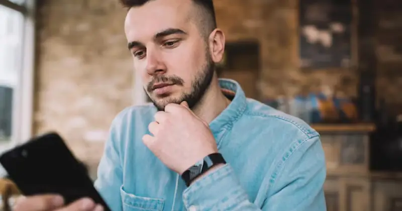 a guy checking his phone