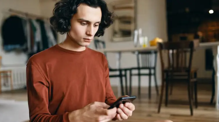 a guy scrolling on his phone