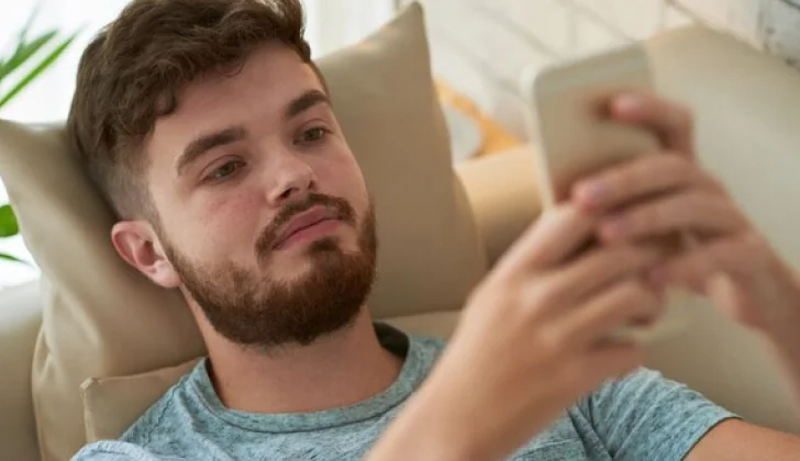 a guy checking his phone