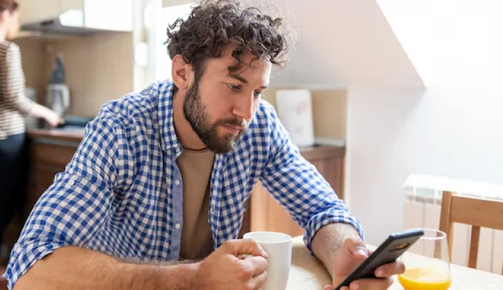 a guy checking his phone