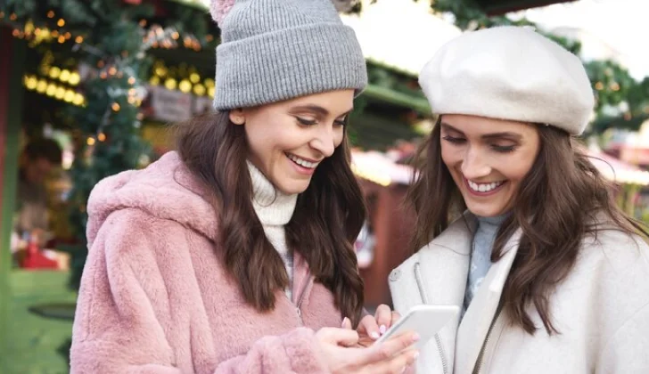 two girls checking their phone