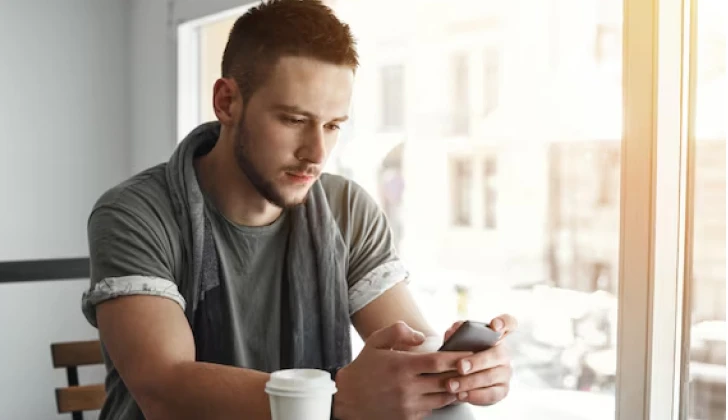a guy checking his phone