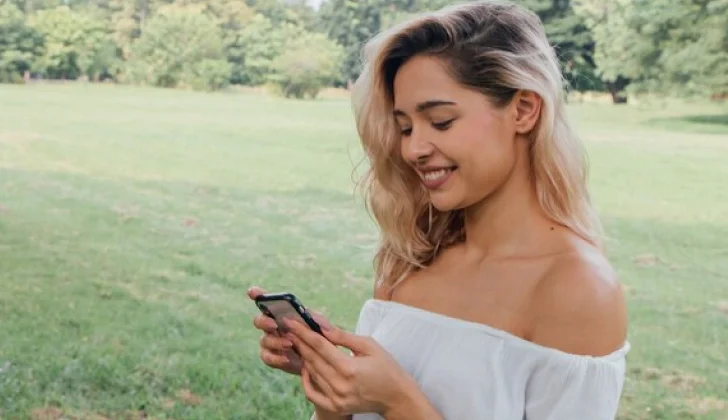 happy girl checking her phone