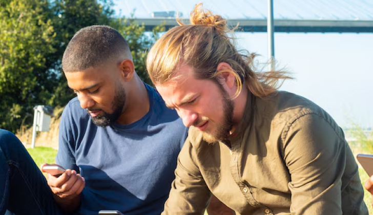 two guys checking social media