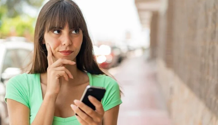 a girl with a phone while thinking