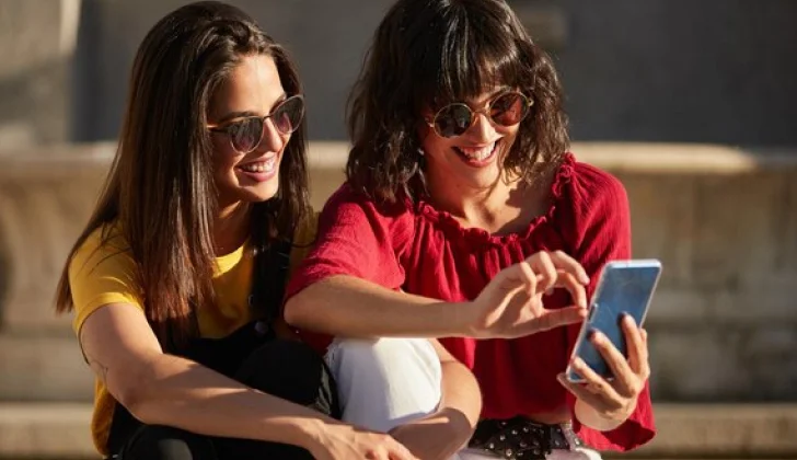 two friends checking social media