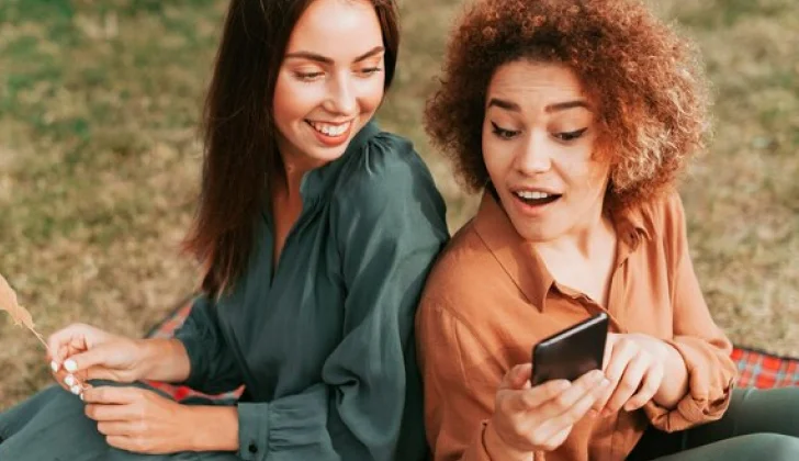 two friends checking social media
