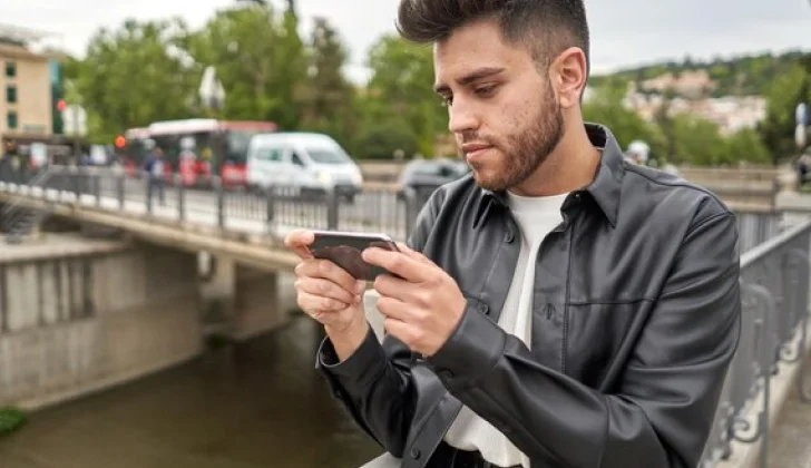 a guy checking his phone