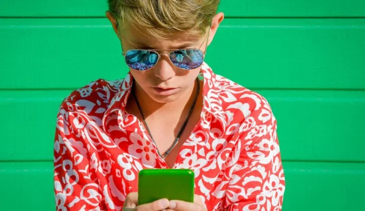a boy scrolling on his phone