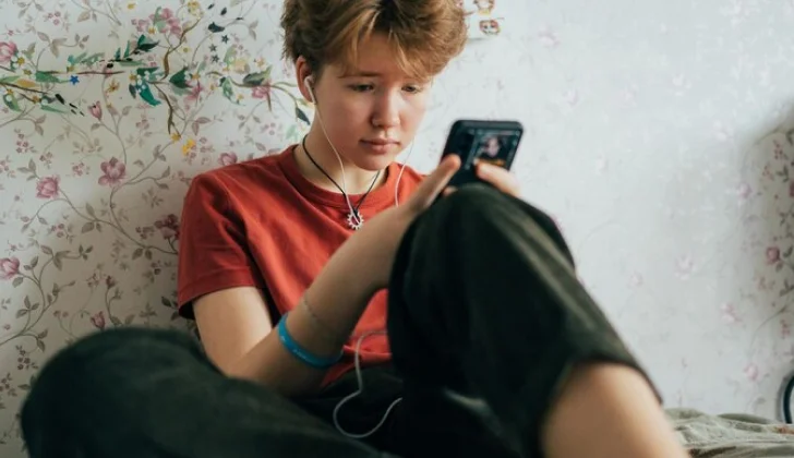 a boy scrolling on social media