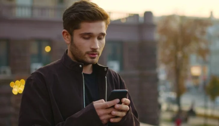 a guy scrolling on his phone