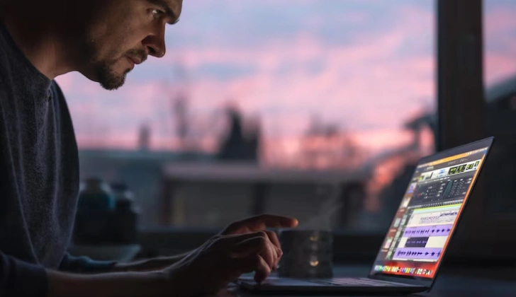 a man creating content on laptop