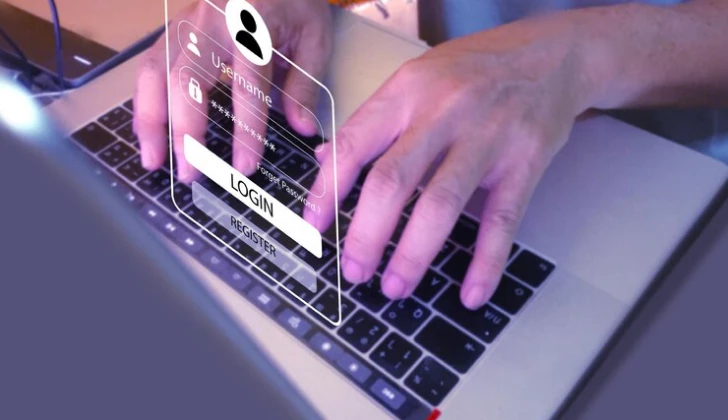 a man typing Log in information