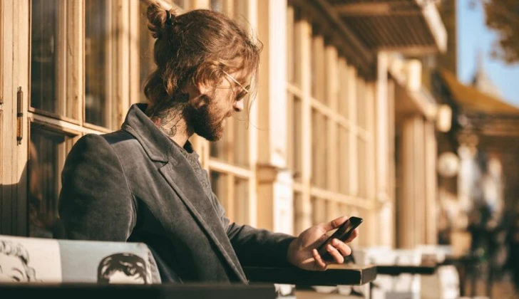 a guy checking his phone