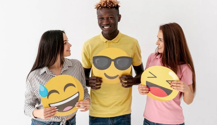 some people holding emoji signs