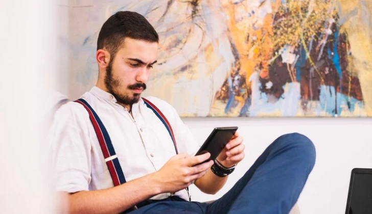 a guys checking his phone