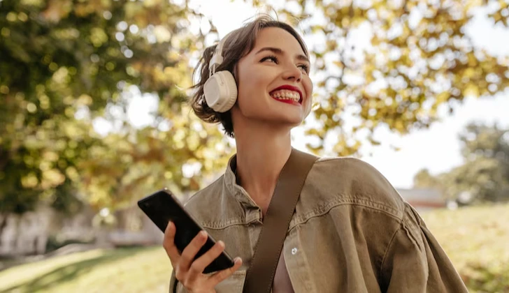 a happy girl listening to music