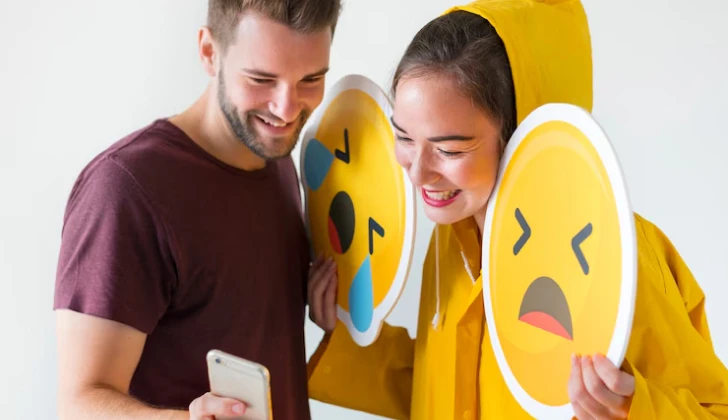 a girl and boy checking their phone