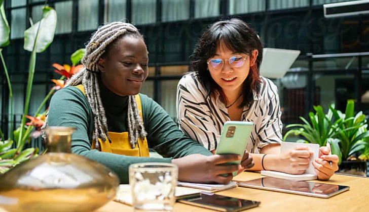 two women scrolling on social media