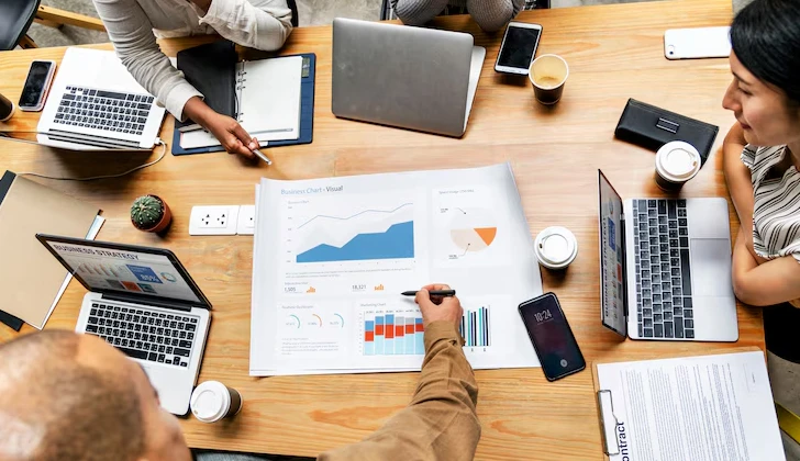a group of people calculating KPI