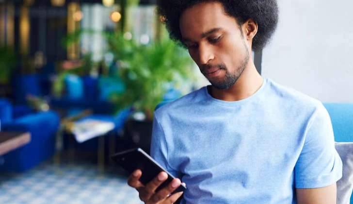 a guy checking his phone