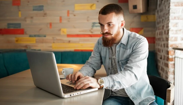 a guy working with laptop