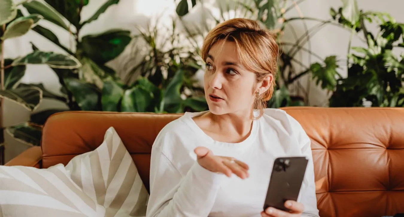 A woman looking questionably at a phone