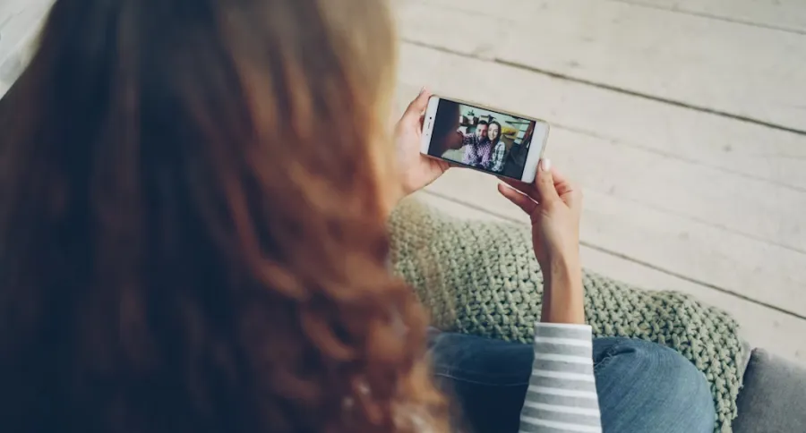 A woman  watching a video on a mobile phone