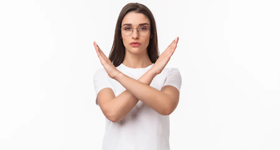 A woman making the X symbol with her hands