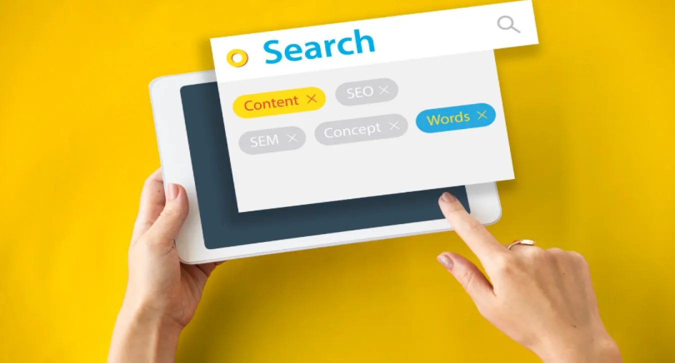 a woman searching for keywords on a tablet with a yellow background