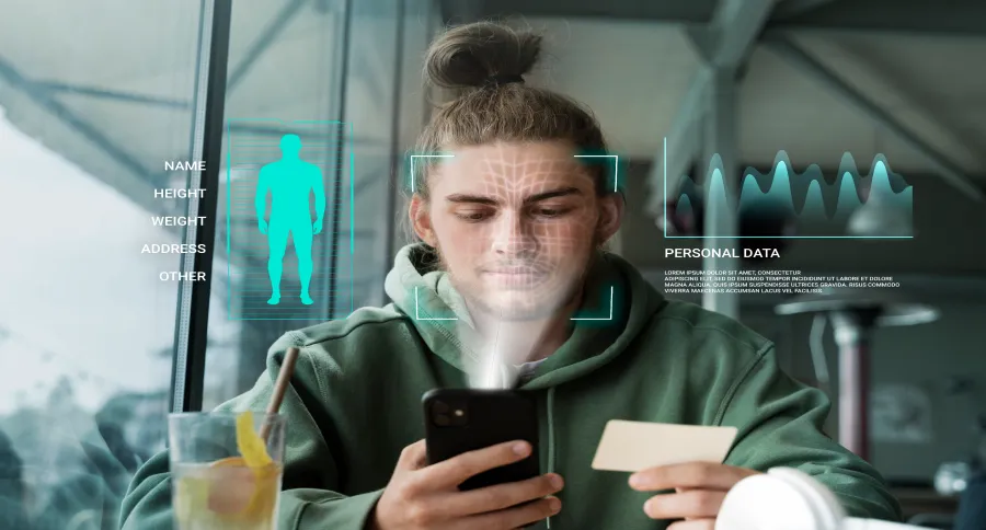 a man at a coffee shop scrolling on his phone, with personal data showing around his head