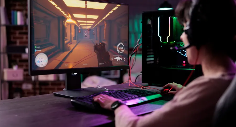 a black haired boy playing a game on a computer