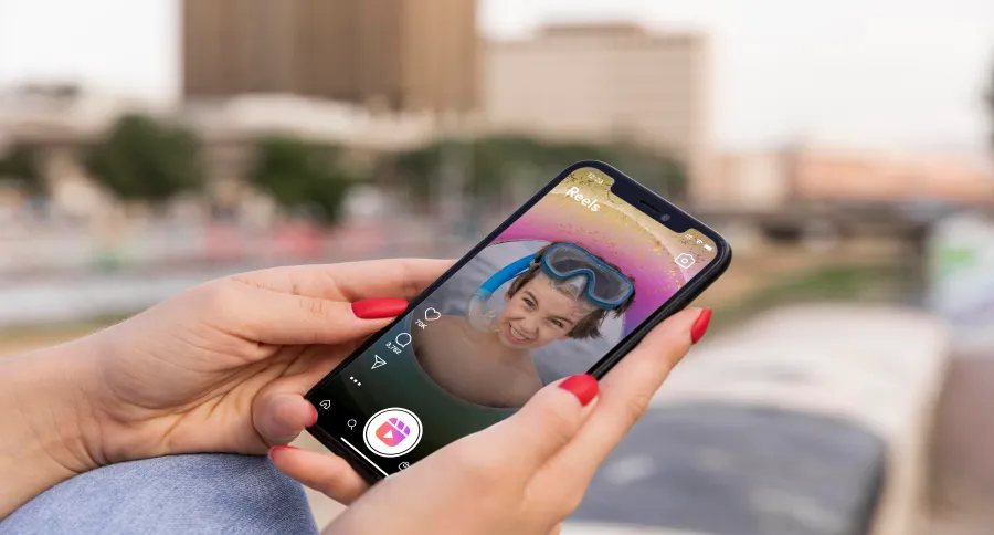 a woman looking through Instagram Reels on their phone