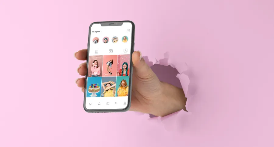 A hand coming out of a pink background showing an Instagram profile