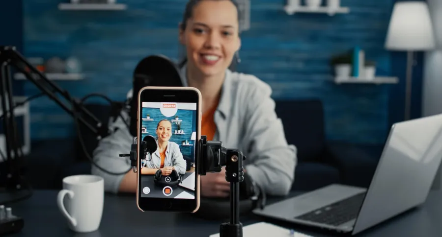 A woman filming herself with a phone holder